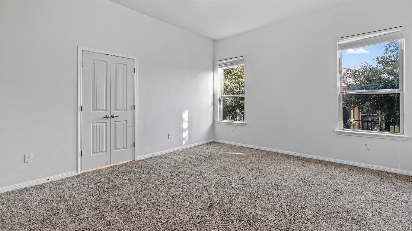 135 Simon Kyle, TX 78640 - Photo 12 of 28 an empty room with windows