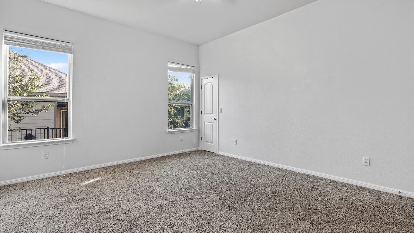 135 Simon Kyle, TX 78640 - Photo 14 of 28 an empty room with windows