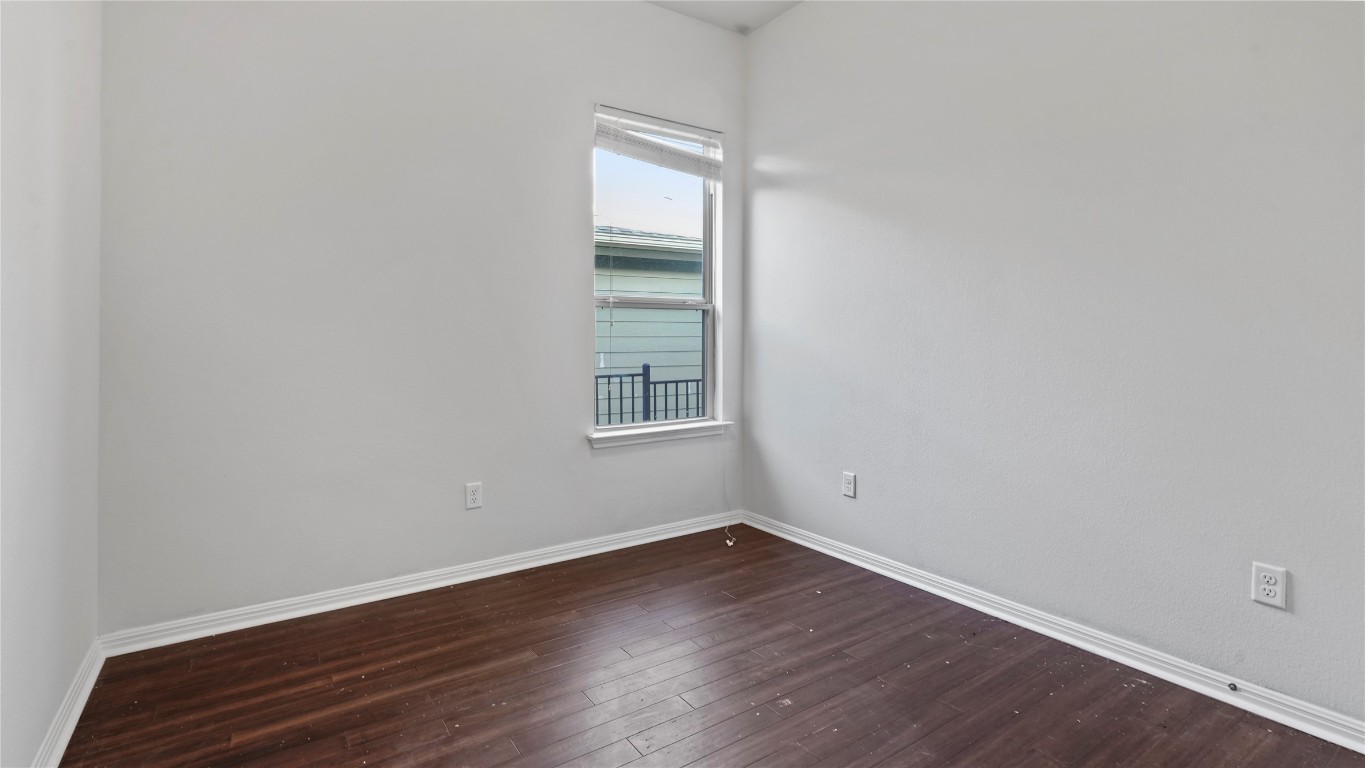 135 Simon Kyle, TX 78640 - Photo 15 of 28 an empty room with wooden floor and windows