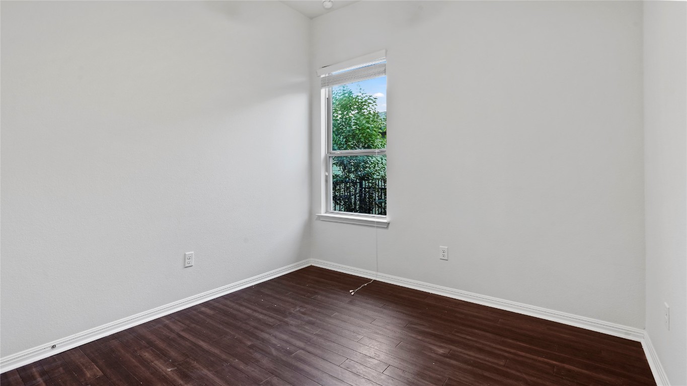 135 Simon Kyle, TX 78640 - Photo 17 of 28 a view of an empty room with wooden floor and a window