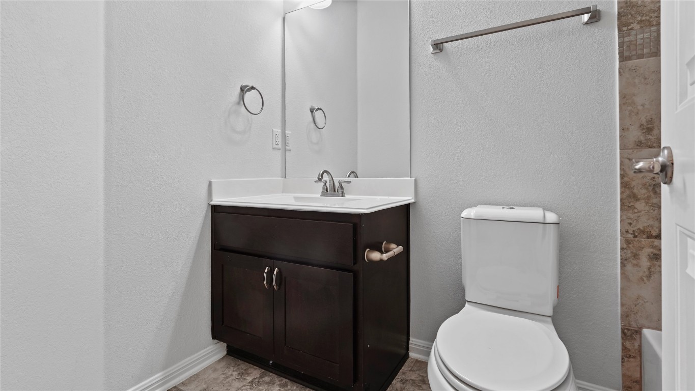 135 Simon Kyle, TX 78640 - Photo 20 of 28 a bathroom with a toilet a sink and mirror