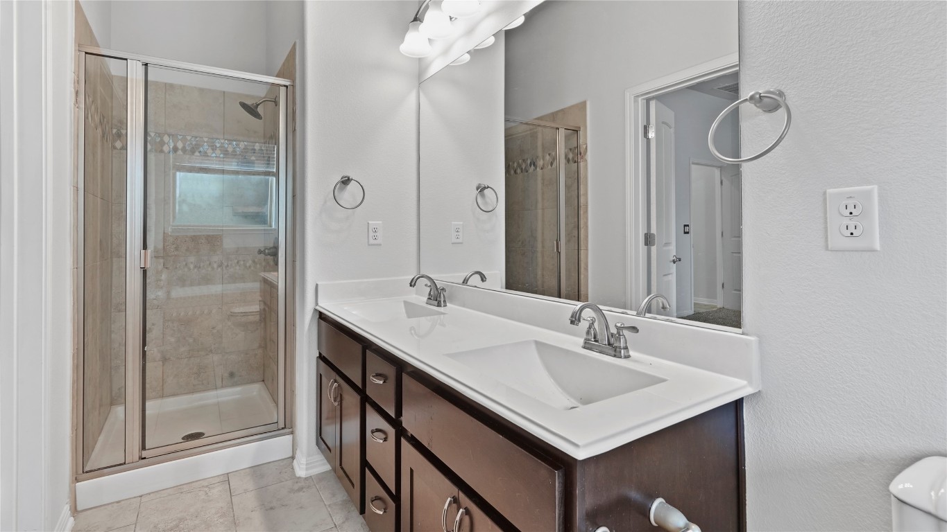 135 Simon Kyle, TX 78640 - Photo 22 of 28 a bathroom with a sink shower and a mirror