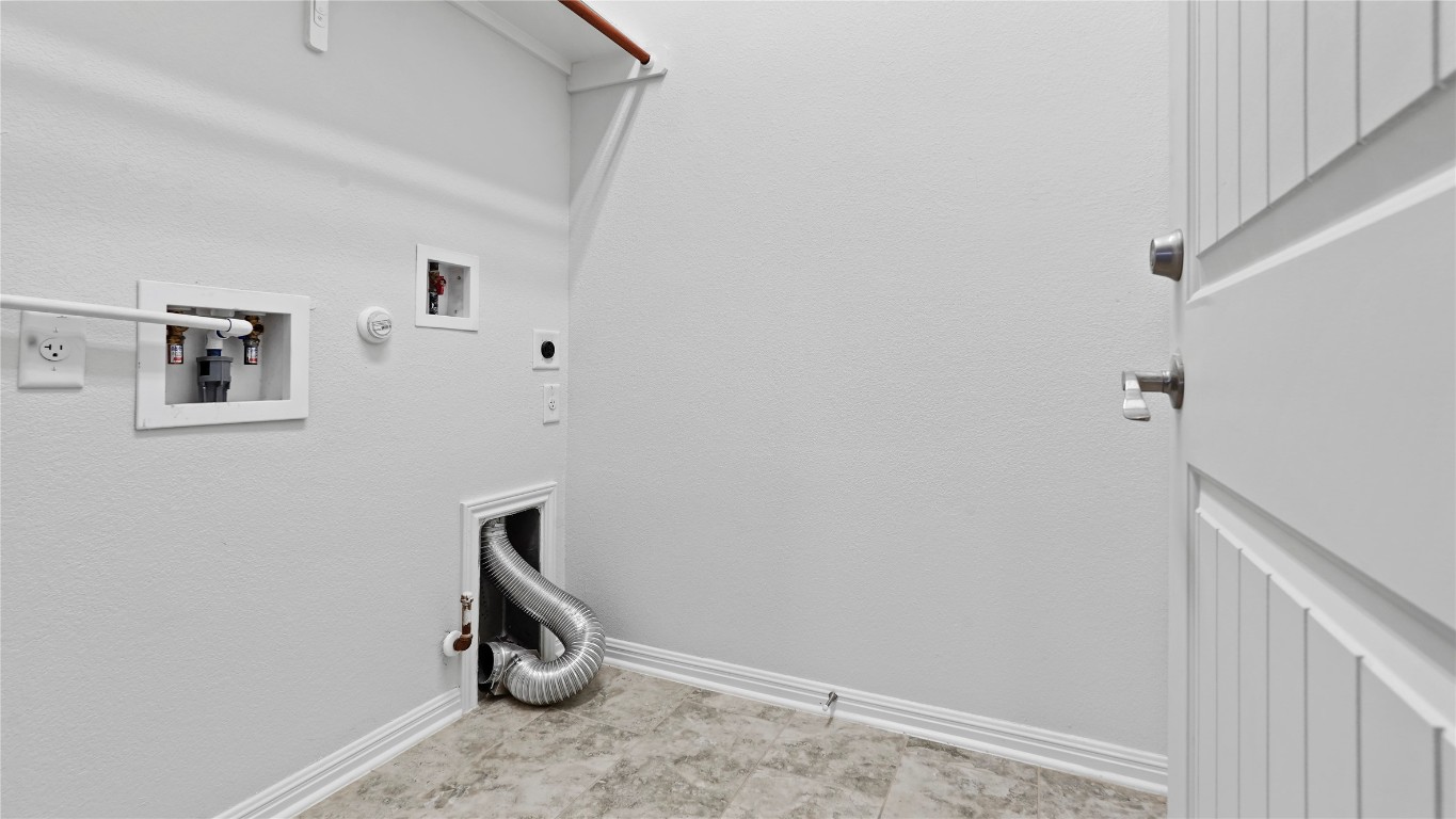 135 Simon Kyle, TX 78640 - Photo 26 of 28 a view of storage and utility room with wooden floor