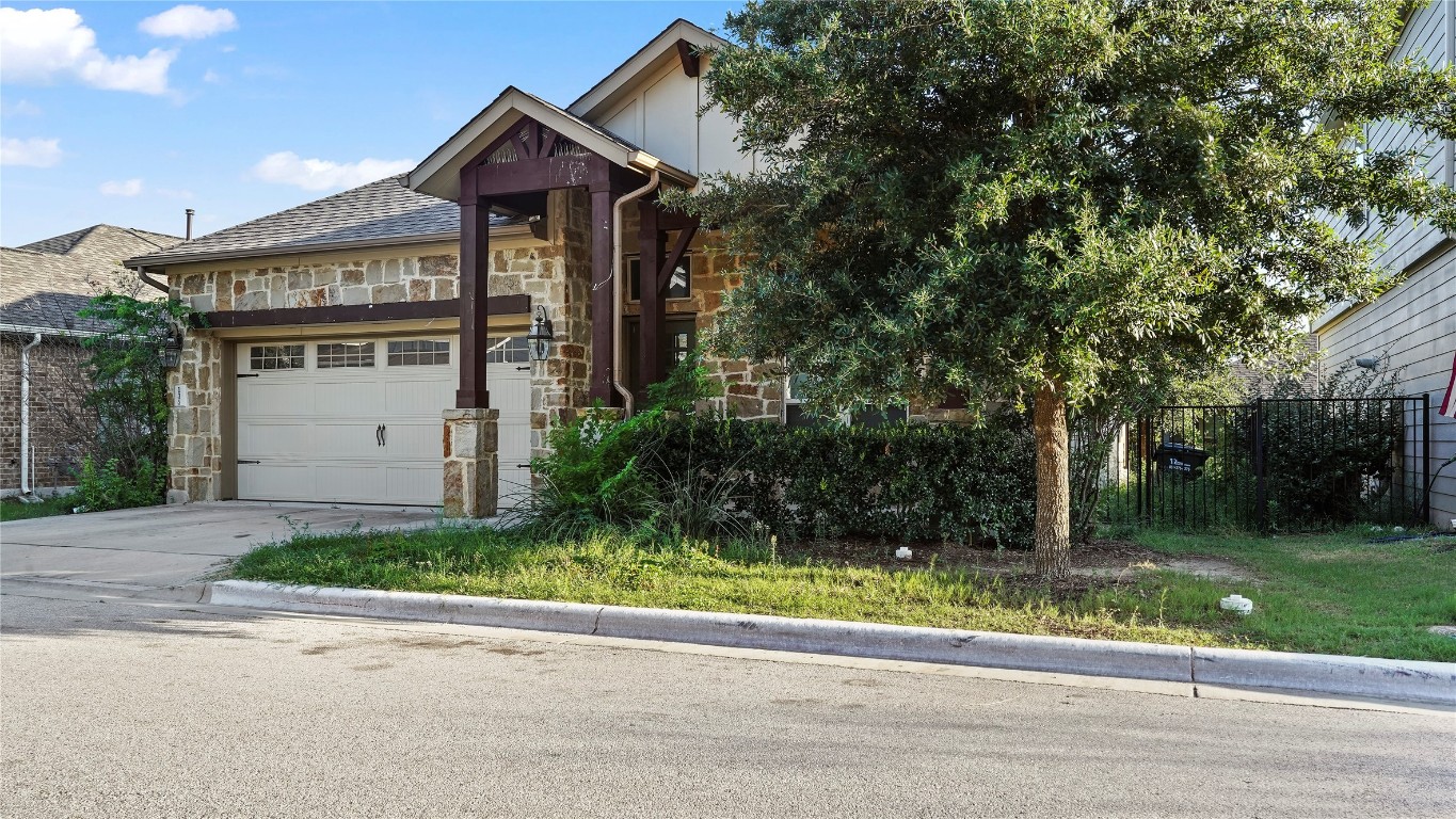 135 Simon Kyle, TX 78640 - Photo 28 of 28 a front view of a house with a yard and a garage