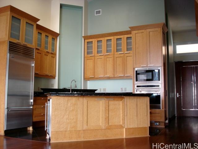 a kitchen with stainless steel appliances granite countertop a refrigerator and a stove top oven