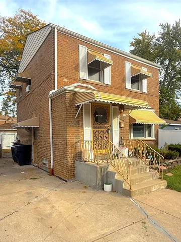 a front view of a house with many windows