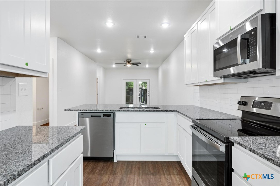 1920 Royal Loop Belton, TX 76513 - Photo 2 of 15 a kitchen with stainless steel appliances granite countertop a sink stove and microwave
