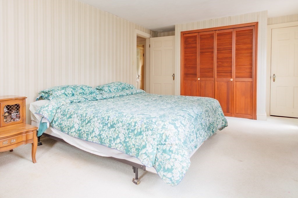 268 Beverly Road Worcester, MA 01605 - Photo 21 of 28 a bed sitting in a spacious bedroom next to a cabinet