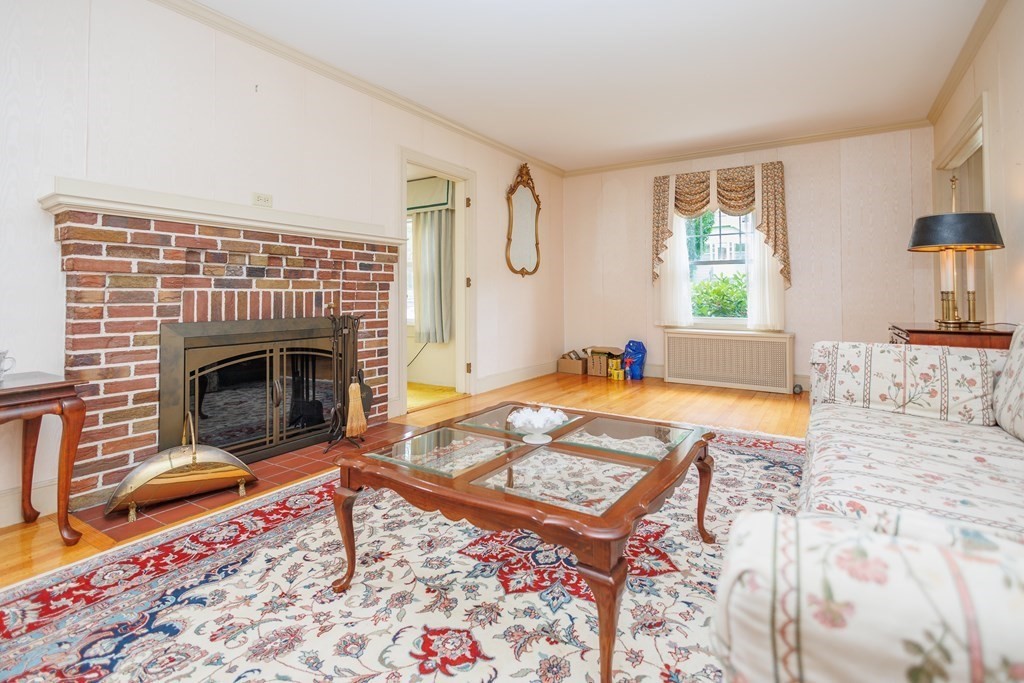 268 Beverly Road Worcester, MA 01605 - Photo 5 of 28 a living room with a rug and a fireplace