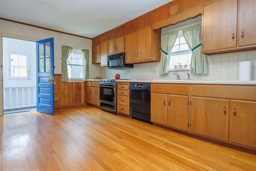 268 Beverly Road Worcester, MA 01605 - Photo 8 of 28 a kitchen with stainless steel appliances granite countertop wooden cabinets a sink and dishwasher with wooden floor