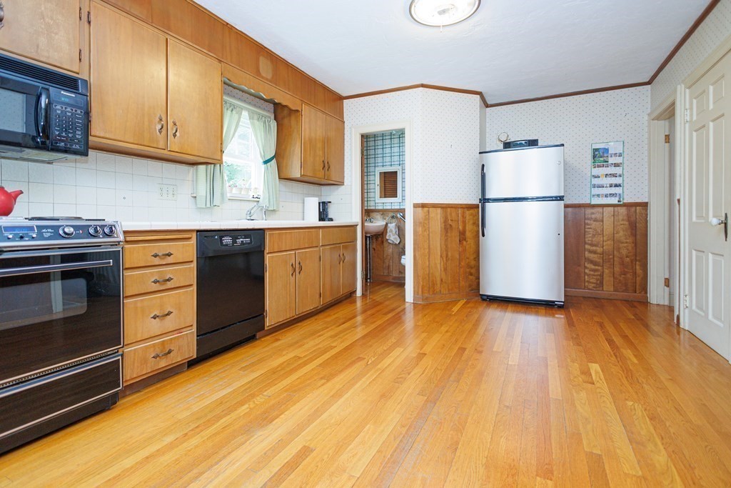 268 Beverly Road Worcester, MA 01605 - Photo 9 of 28 a kitchen with stainless steel appliances granite countertop a refrigerator a stove and a wooden floors