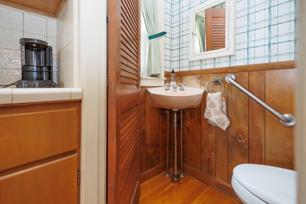 268 Beverly Road Worcester, MA 01605 - Photo 10 of 28 a bathroom with a sink a toilet a mirror and shower