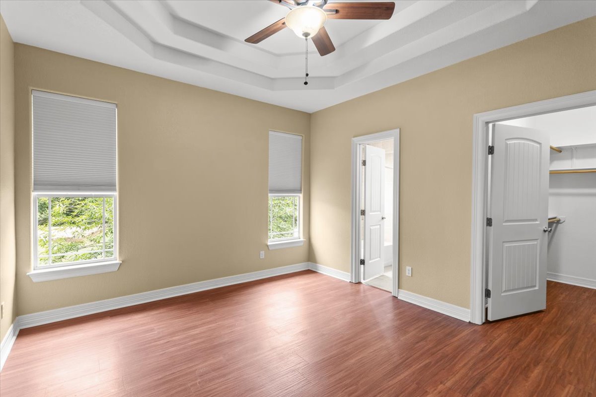 437 Balch Road Elgin, TX 78621 - Photo 12 of 37 A primary bedroom offering generous space and a beautiful tray ceiling.