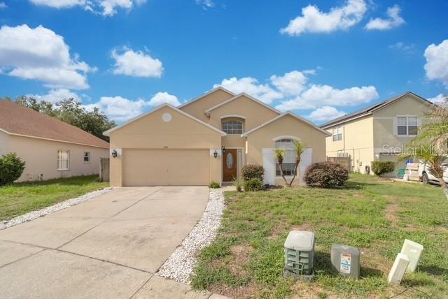 5120 Shale Ridge Trail Orlando, FL 32818 - Photo 1 of 15 a front view of a house with garden