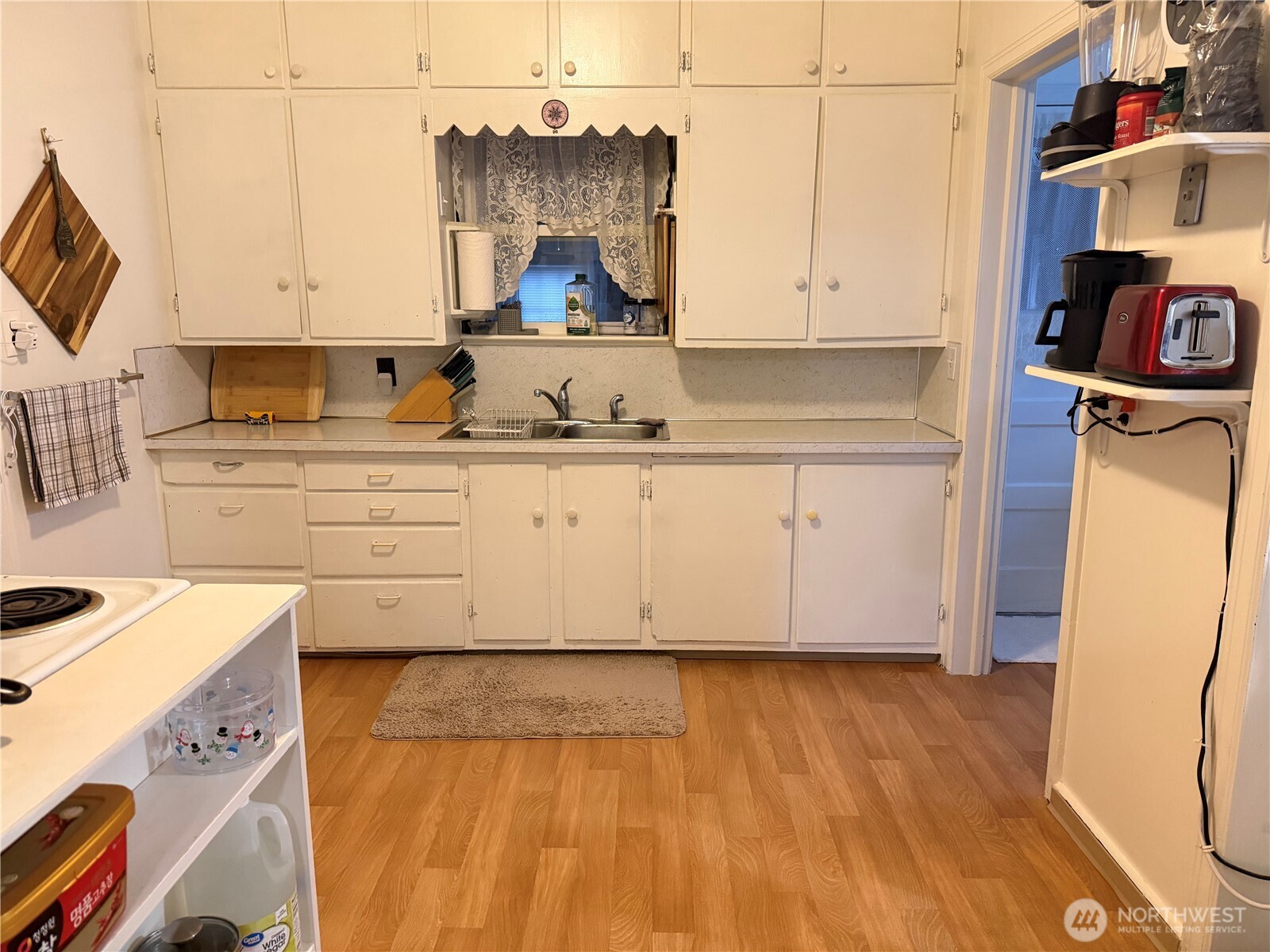 409 Birch Street South Omak, WA 98841 - Photo 11 of 32 a kitchen with granite countertop white cabinets and white appliances
