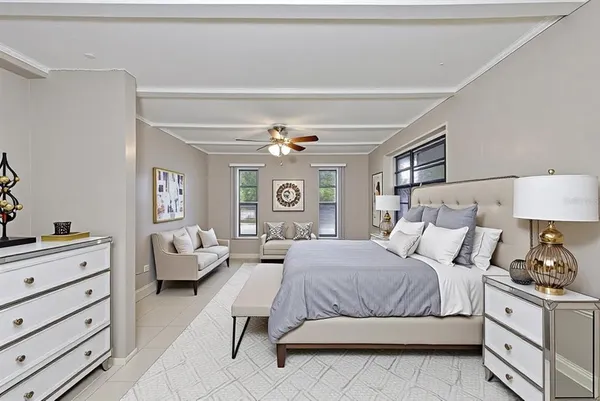 a bedroom with a bed and ceiling fan