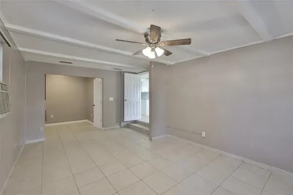 a view of an empty room and a ceiling fan
