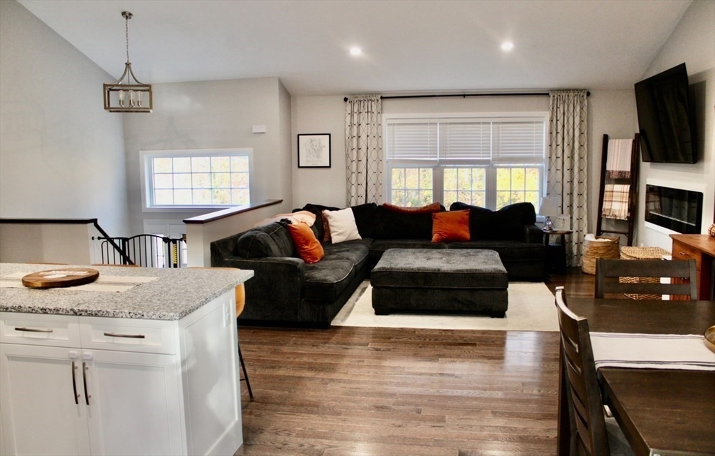 67 Mason Road Dudley, MA 01571 - Photo 11 of 33 a living room with fireplace furniture and a flat screen tv