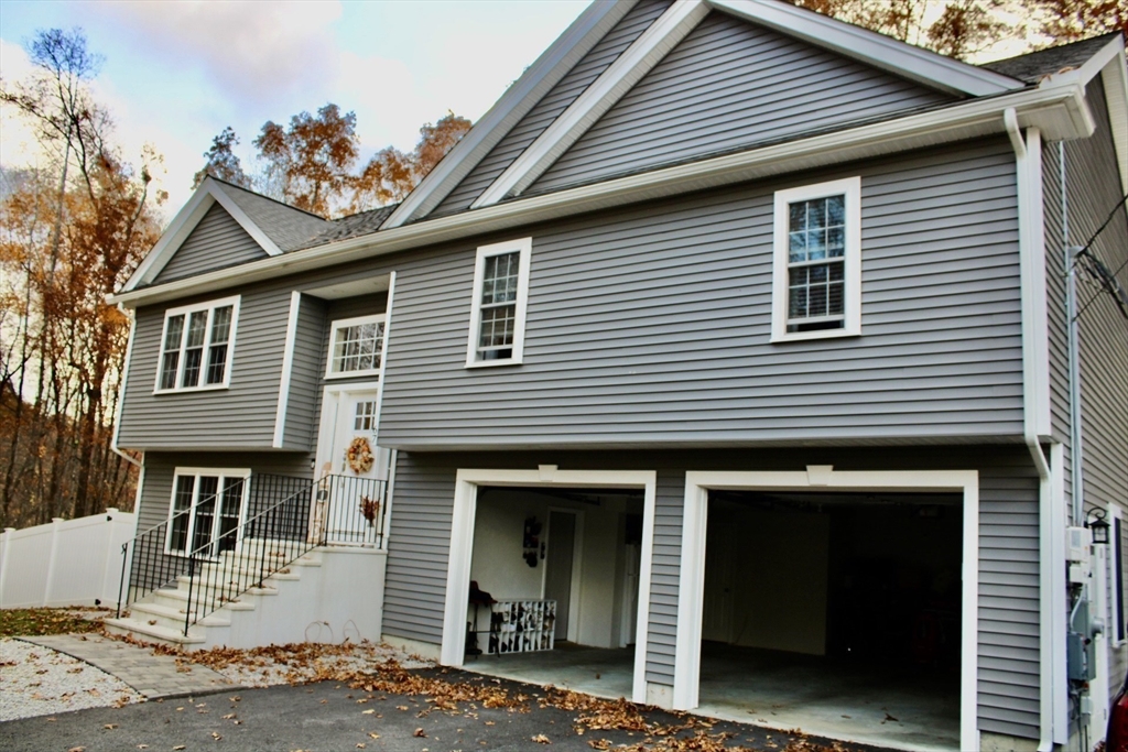 67 Mason Road Dudley, MA 01571 - Photo 5 of 33 a front view of a house with a yard