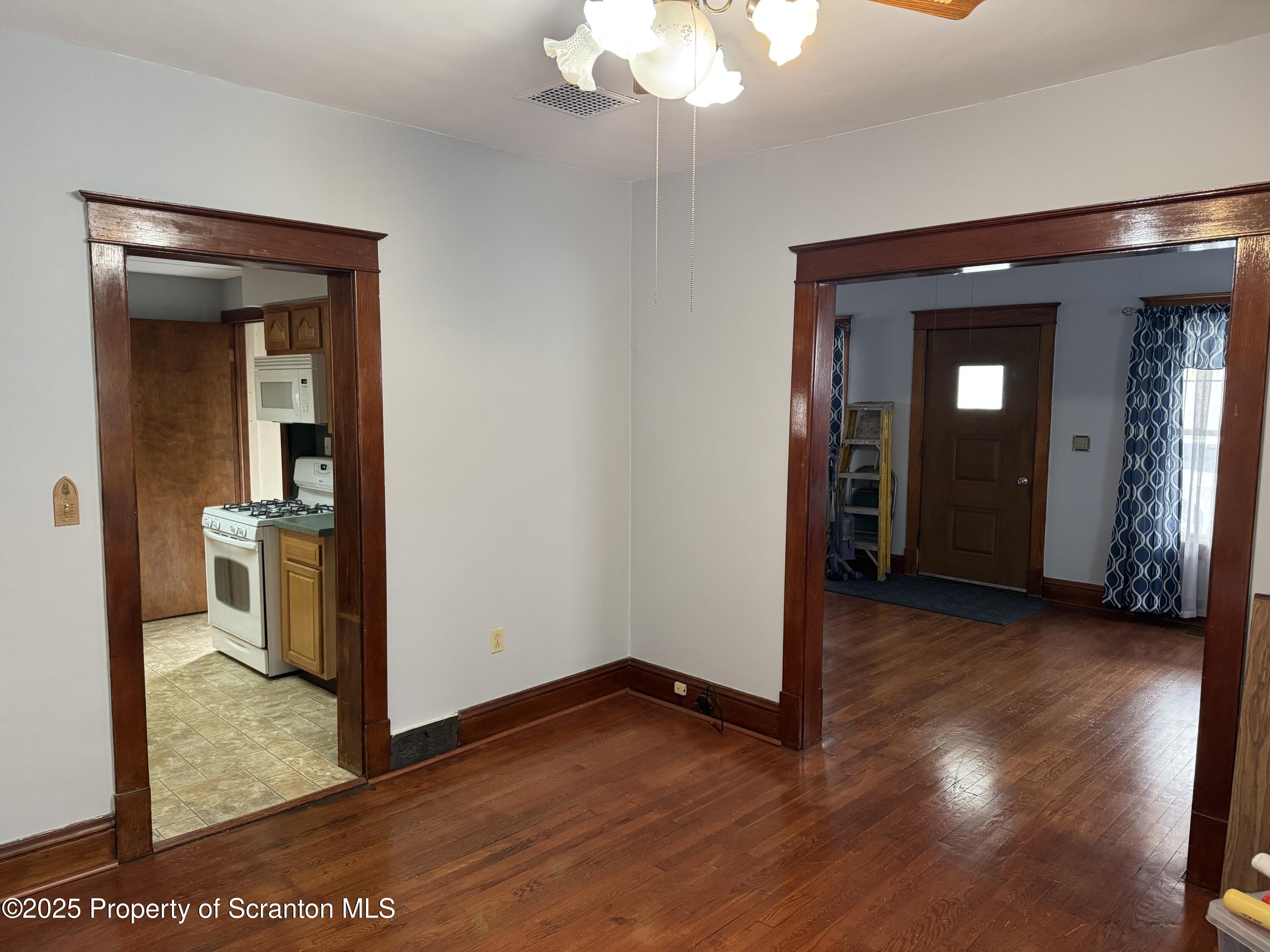 837 Matthew Avenue Scranton, PA 18510 - Photo 13 of 31 a view of a hallway with wooden floor and a living room