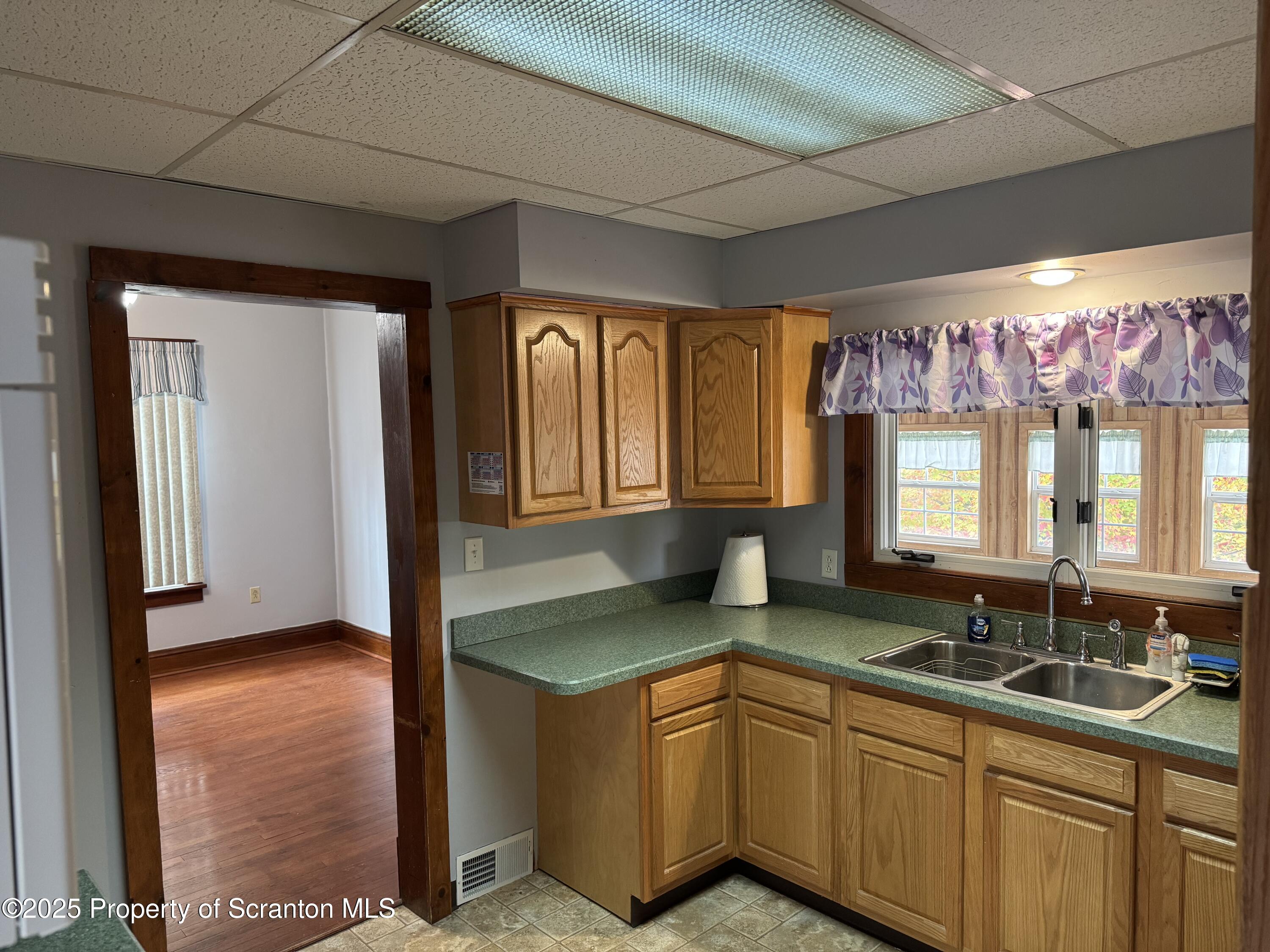 837 Matthew Avenue Scranton, PA 18510 - Photo 14 of 31 a kitchen with granite countertop a sink and a refrigerator