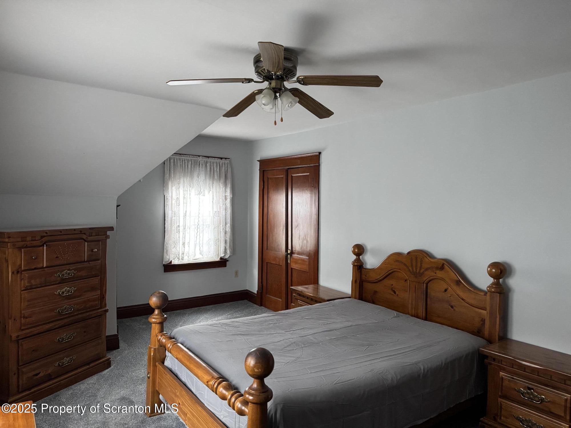 837 Matthew Avenue Scranton, PA 18510 - Photo 21 of 31 a bedroom with a bed and a chandelier
