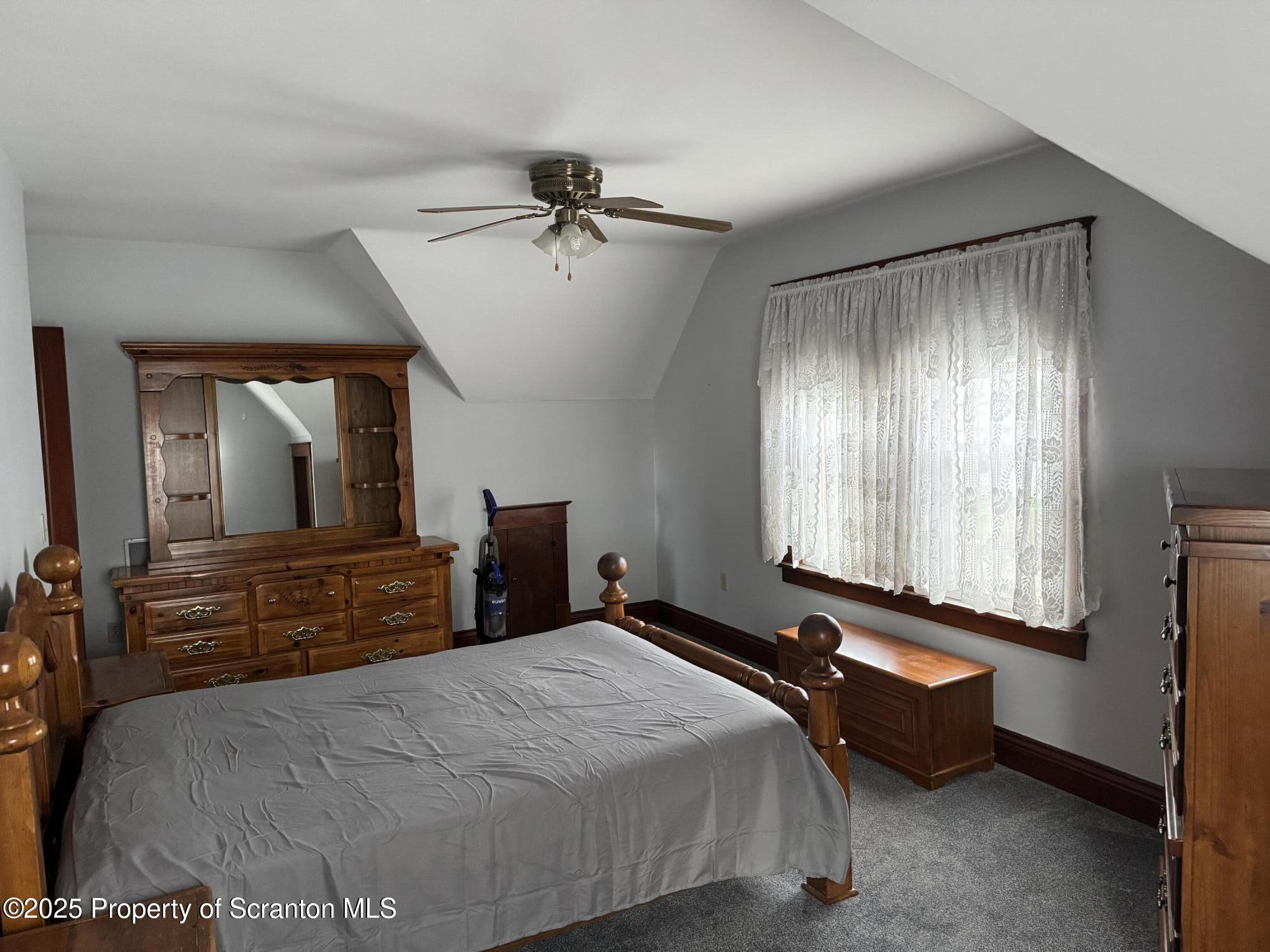 837 Matthew Avenue Scranton, PA 18510 - Photo 22 of 31 a bedroom with a bed and wooden floor