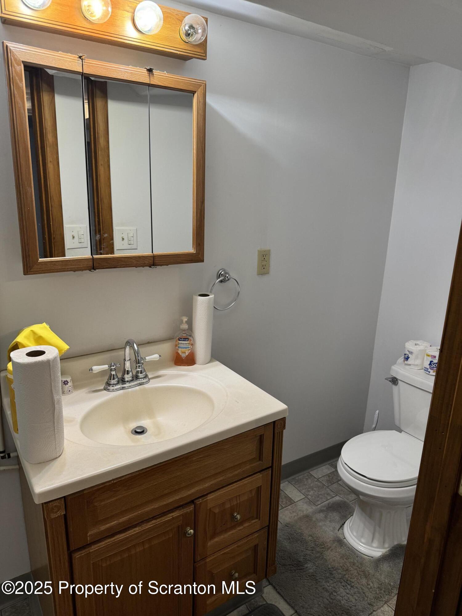837 Matthew Avenue Scranton, PA 18510 - Photo 28 of 31 a bathroom with a sink a toilet and mirror