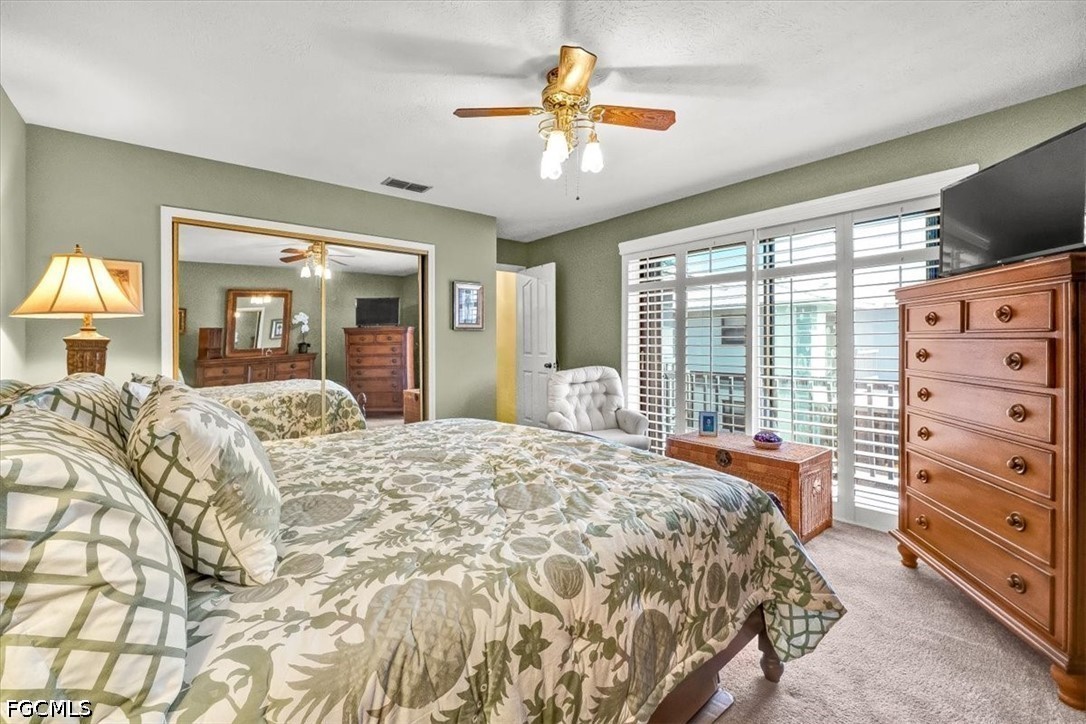 707 Hoover Dike Road, Unit 904 Clewiston, FL 33440 - Photo 37 of 41 a bedroom with a bed and a chandelier with a flat tv screen