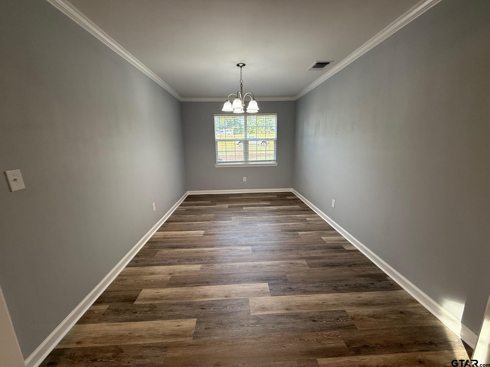 3248 Highway 79 Henderson, TX 75652 - Photo 11 of 44 wooden floor in an empty room with a window