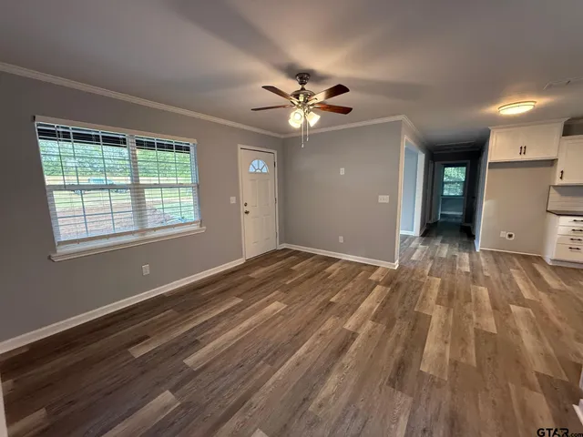 wooden floor in an empty room with a window