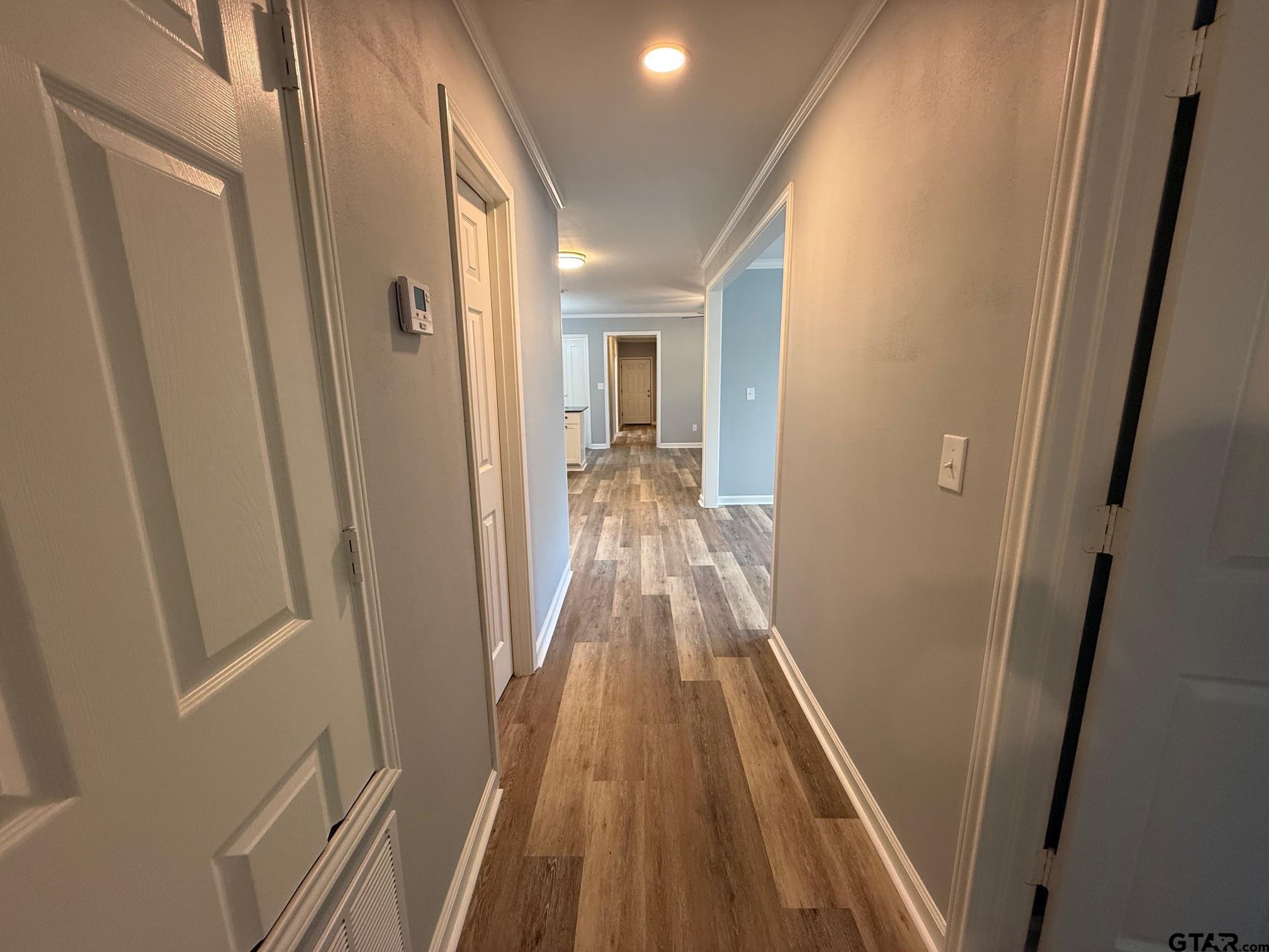 3248 Highway 79 Henderson, TX 75652 - Photo 18 of 44 a view of a hallway with wooden floor and staircase