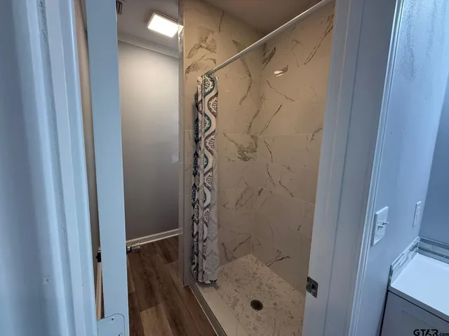 a bathroom with a sink a mirror and a shower