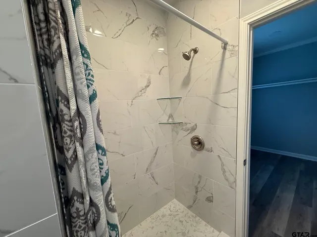 a bathroom with a bathtub and shower