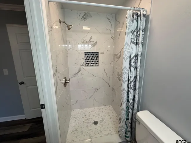 a bathroom with a toilet sink and mirror