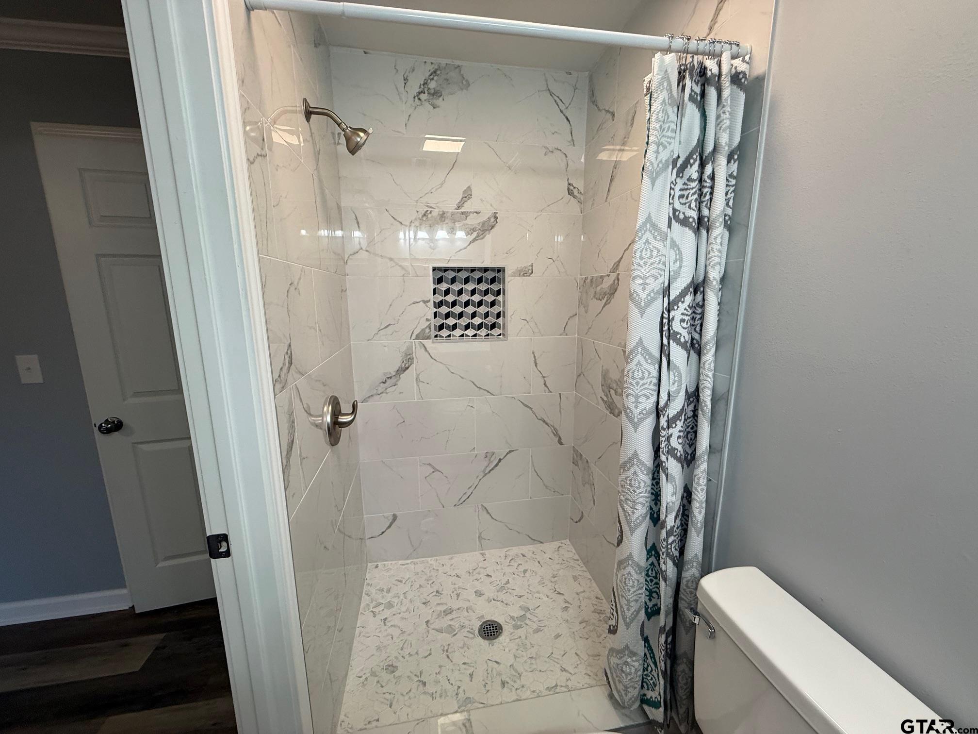 3248 Highway 79 Henderson, TX 75652 - Photo 27 of 44 a bathroom with a shower and toilet