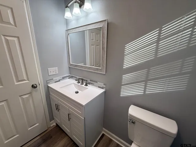 a view of a closet area with wooden floor