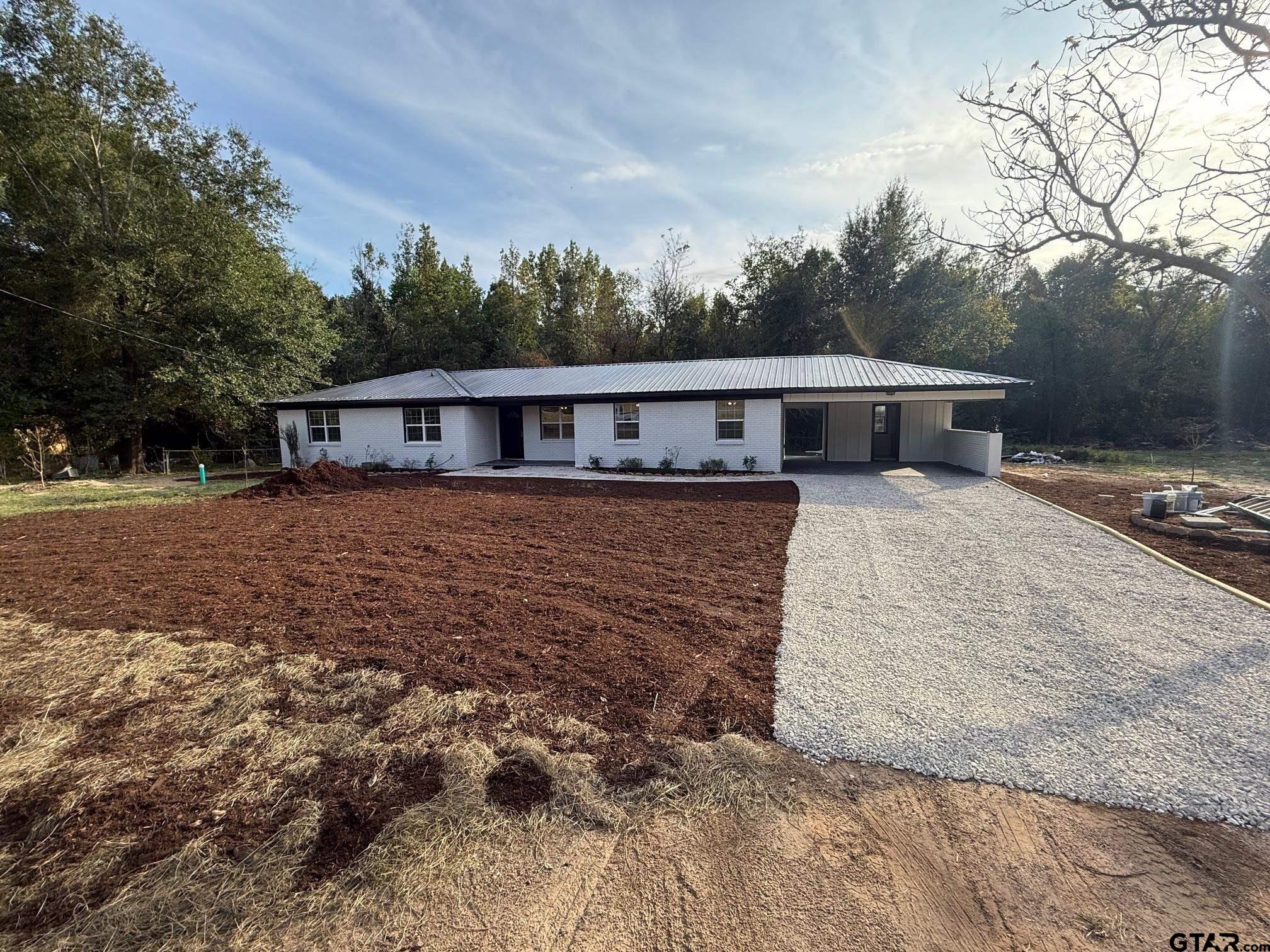 3248 Highway 79 Henderson, TX 75652 - Photo 35 of 44 a view of a house with wooden deck and trees
