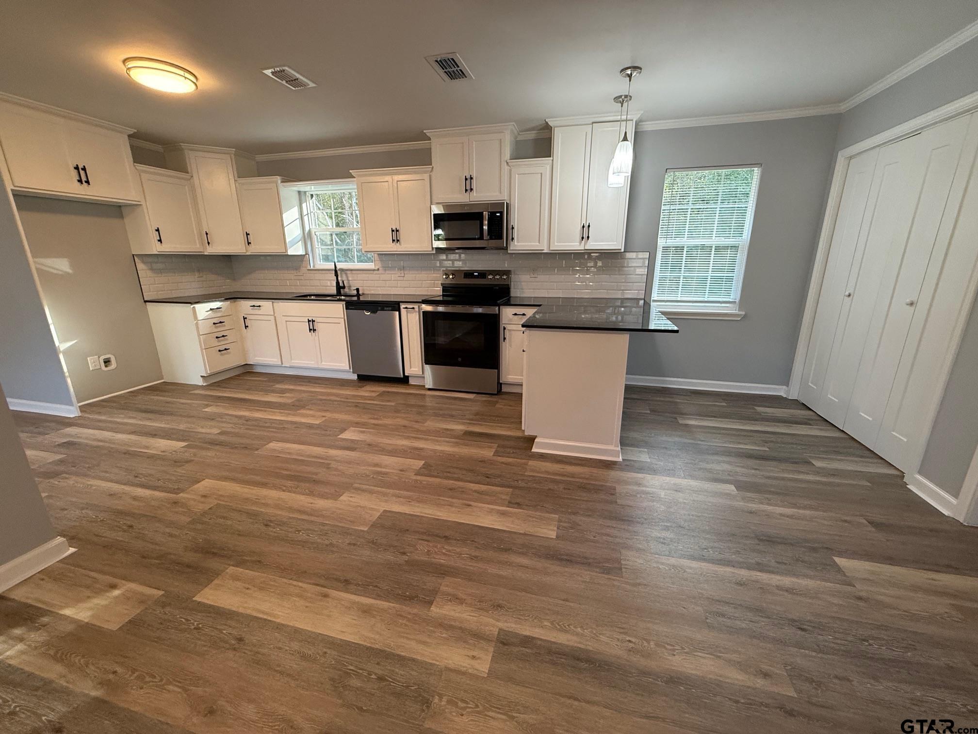 3248 Highway 79 Henderson, TX 75652 - Photo 5 of 44 a large kitchen with stainless steel appliances granite countertop a stove and a sink