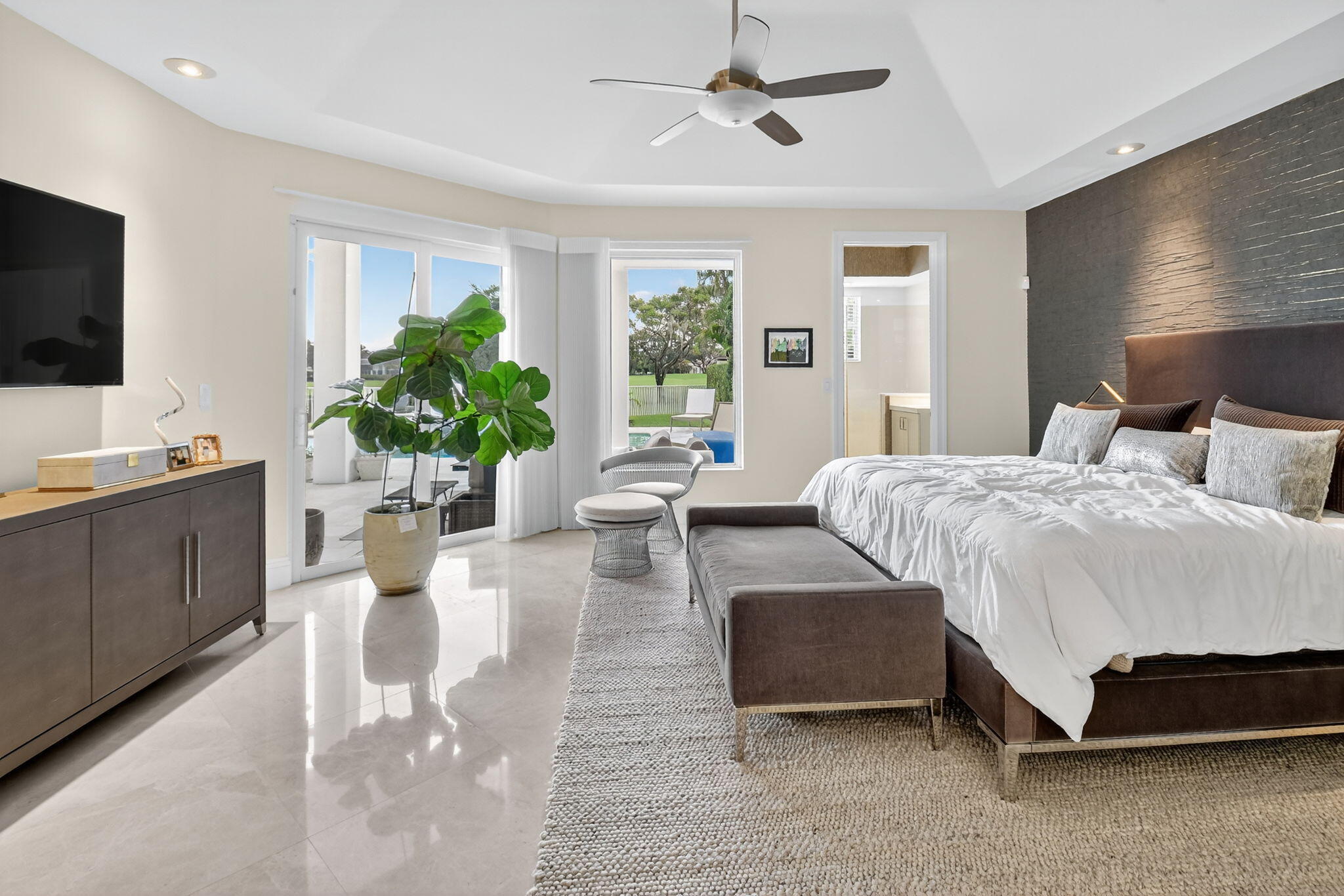2563 Northwest 63rd Street Boca Raton, FL 33496 - Photo 25 of 65 a bedroom with a bed couches and a flat tv screen