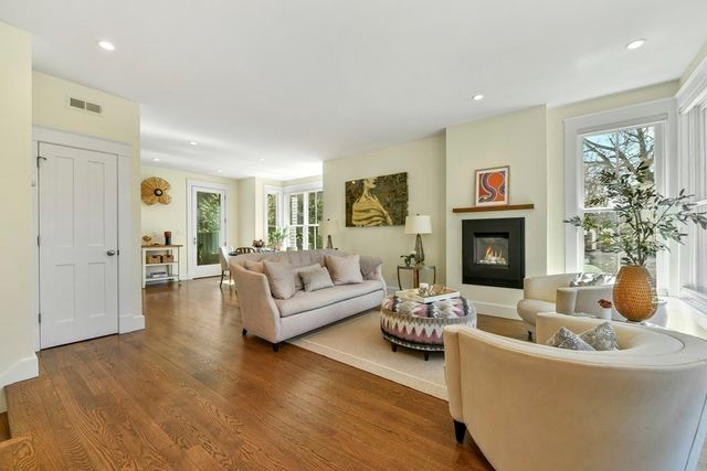 a living room with furniture flat screen tv and a fireplace
