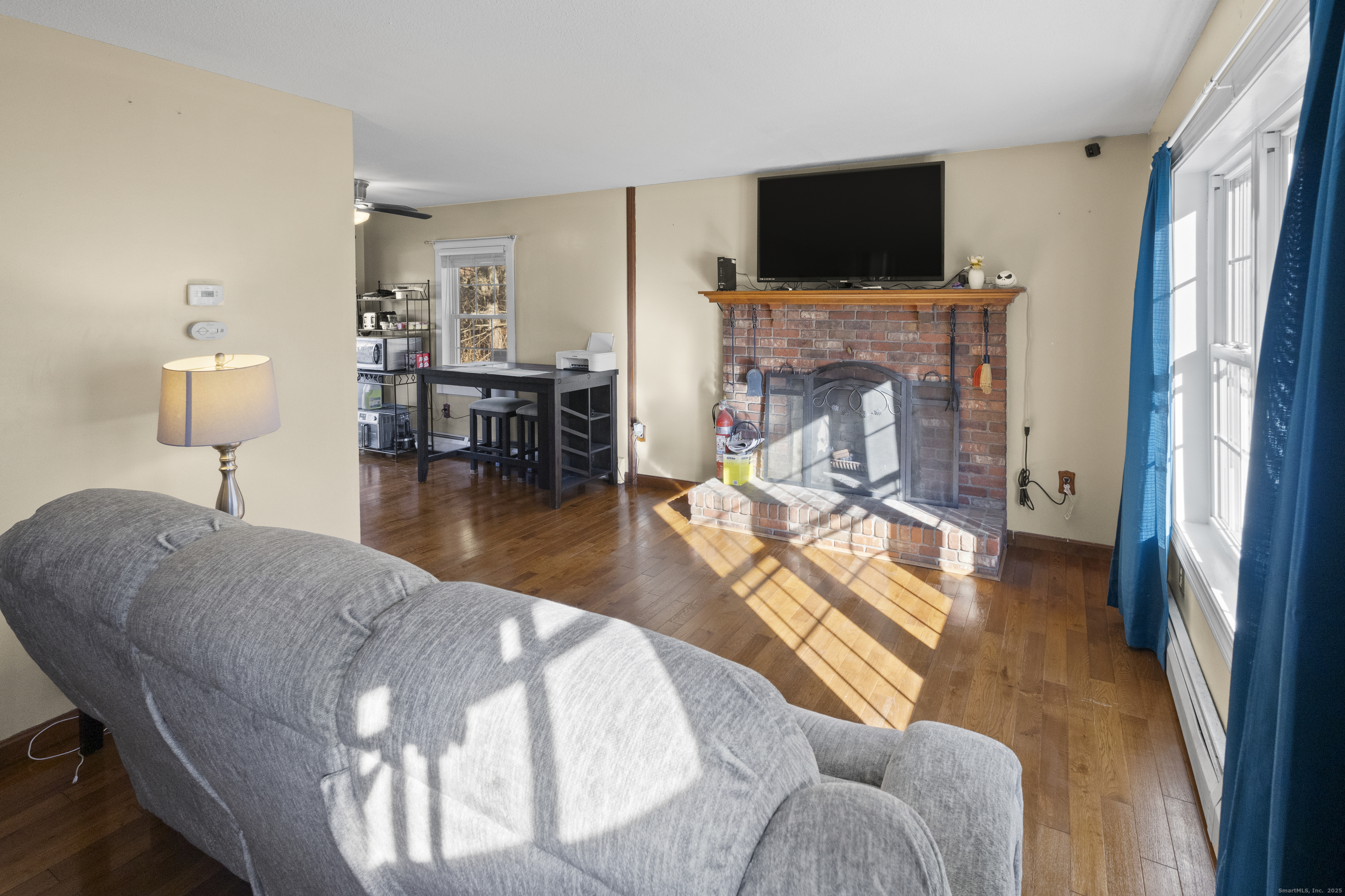 230 Cemetery Road Plainfield, CT 06374 - Photo 12 of 29 a living room with furniture a flat screen tv and a fireplace