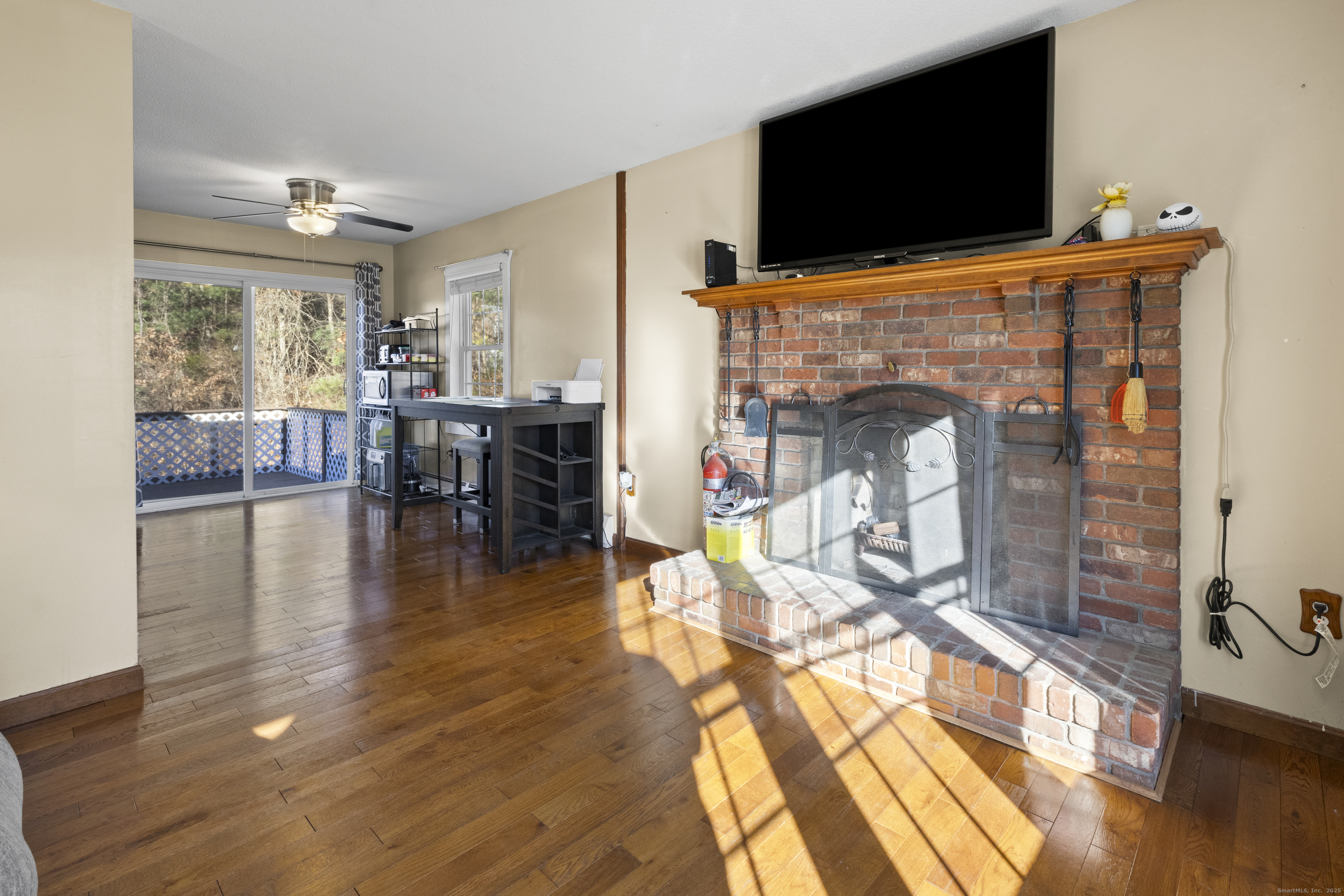 230 Cemetery Road Plainfield, CT 06374 - Photo 16 of 29 a living room with furniture a flat screen tv and a fireplace
