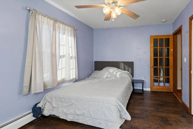 a bed sitting in a bedroom next to a window