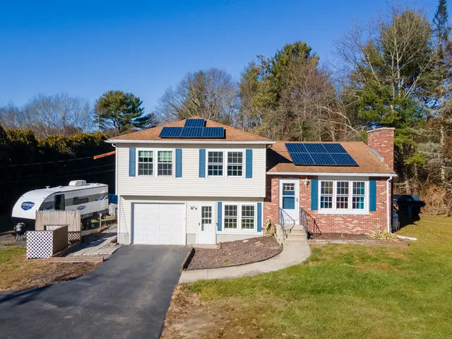 a front view of a house with a yard