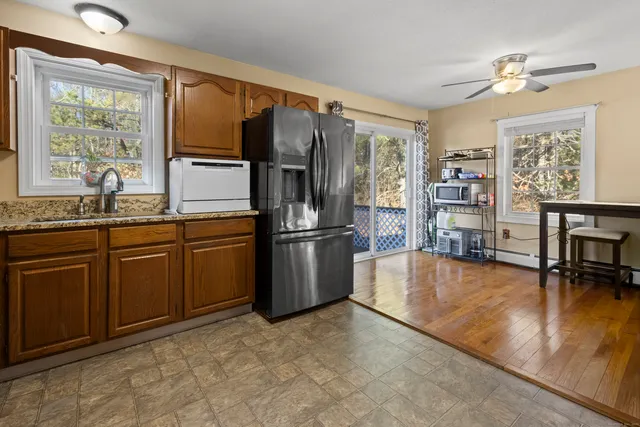 a kitchen with stainless steel appliances granite countertop a refrigerator a stove and a sink with granite countertops