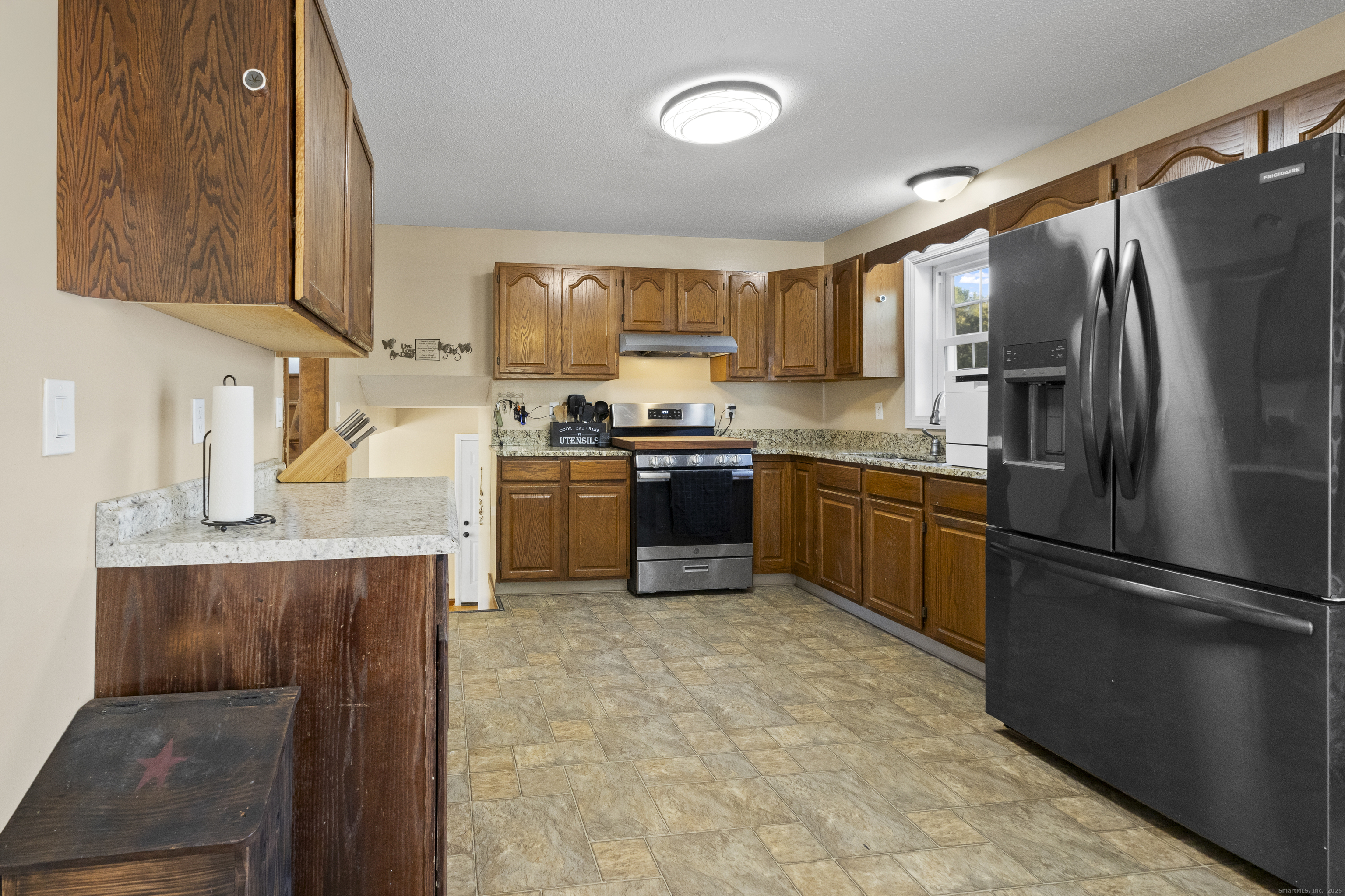 230 Cemetery Road Plainfield, CT 06374 - Photo 9 of 29 a kitchen with stainless steel appliances granite countertop a refrigerator a stove top oven a sink and dishwasher