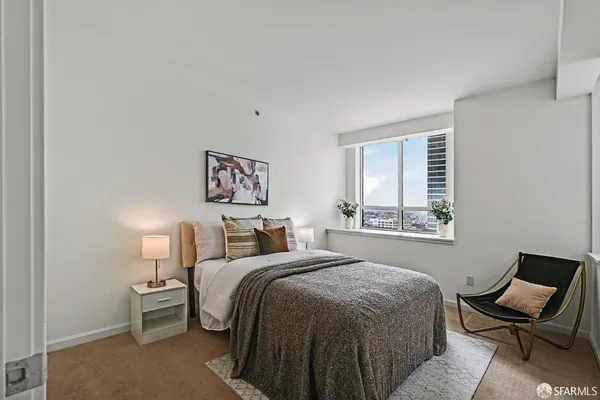 a bedroom with a bed and chair