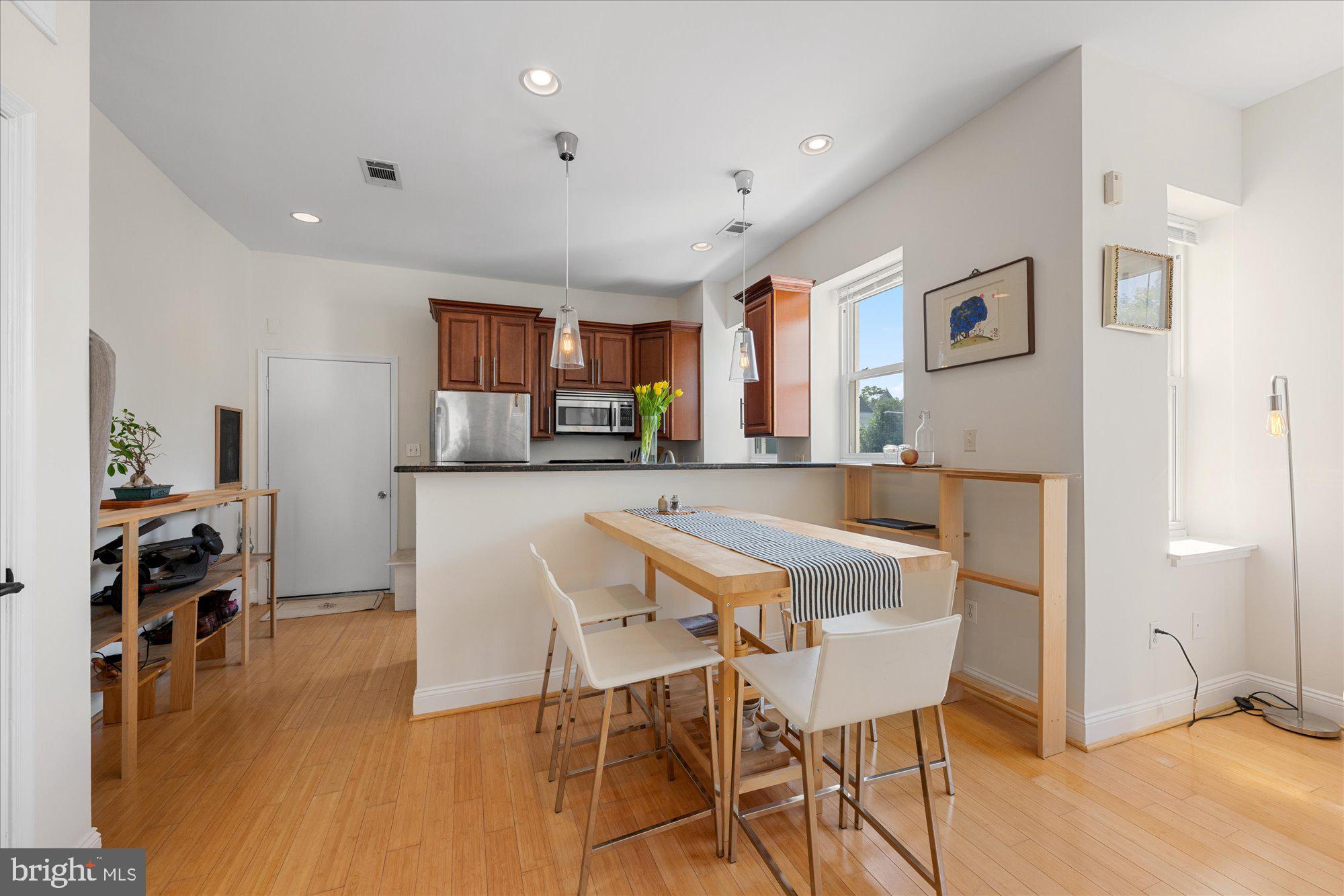 1124 E Street Northeast, Unit A Washington, DC 20002 - Photo 3 of 10 a view of a dining room with furniture and a kitchen