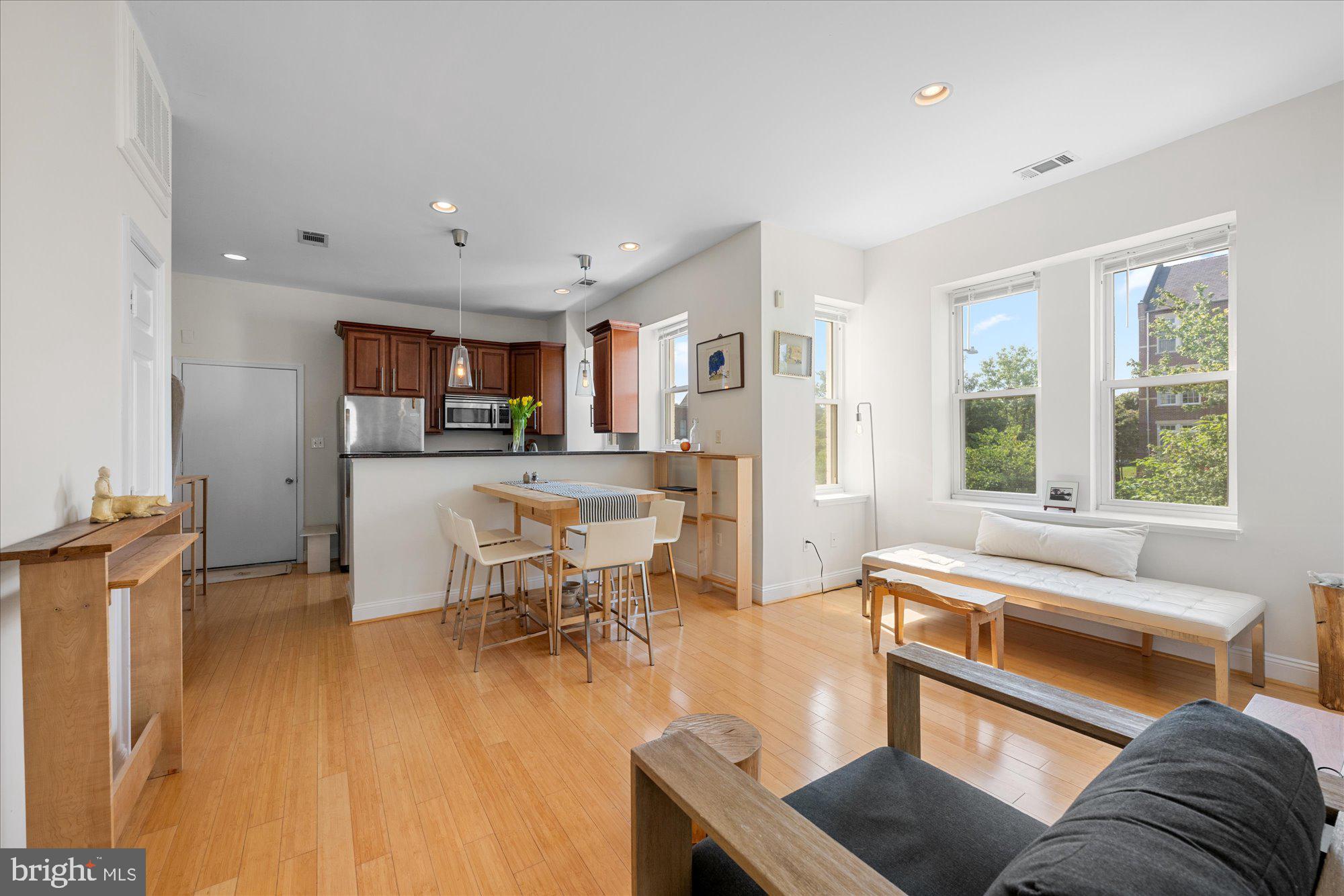 1124 E Street Northeast, Unit A Washington, DC 20002 - Photo 5 of 10 a living room with furniture and a large window